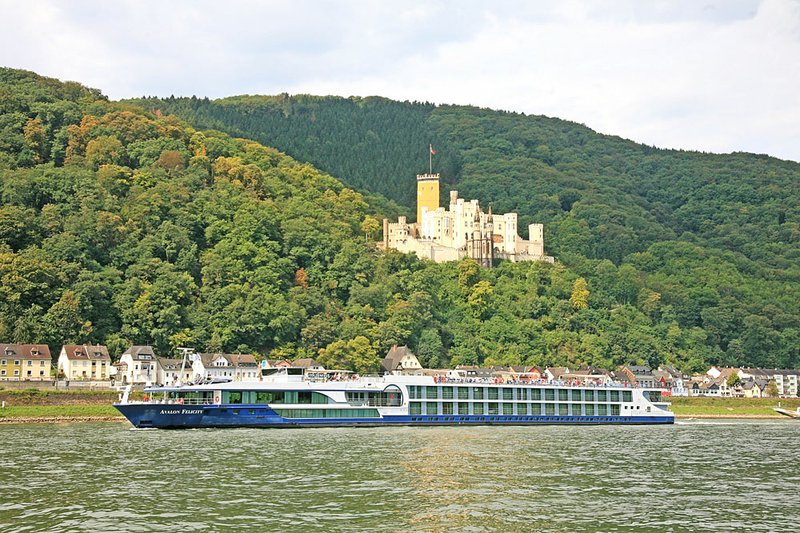 One of the ships in Avalon Waterways’ fleet sails past a medieval hilltown along the Rhine River. Riverboat cruising is becoming more and more popular because passengers enjoy the intimacy of the smaller ships and river-port calls.

