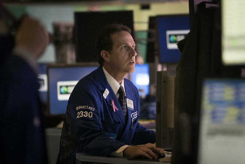 A Barclays PLC trader works Monday on the floor of the New York Stock Exchange. Stock indexes fell in light trading as investors wait for third-quarter earnings reports.