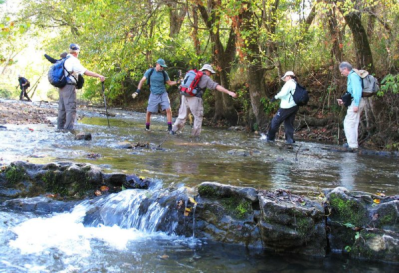 Ozark Society members have to get used to wet ankles, but they don’t cross chilly creeks alone. In this 2007 outing, guides help hikers across the Buffalo National River. 