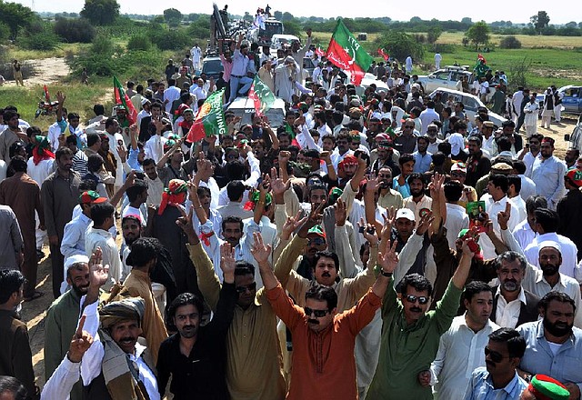 Supporters of opposition politician Imran Khan march Sunday on the outskirts of Tank, Pakistan, to protest U.S. drone attacks. The group was turned back near the border with Afghanistan by Pakistan’s military. 