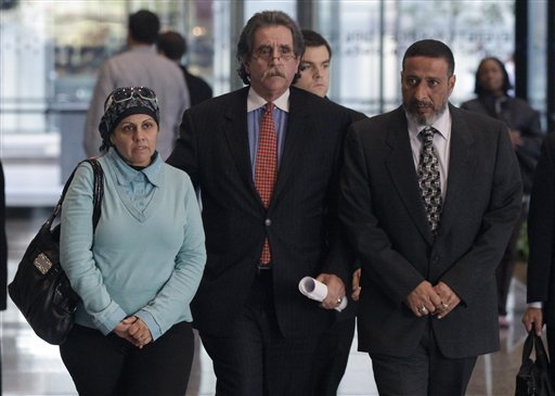 Attorney Thomas Durkin, center, leads his client Adel Daoud's parents, Mona, left, and Ahmed, through the federal courthouse lobby Thursday, Oct. 11, 2012, in Chicago. Adel Daoud pleaded not guilty on federal terrorism charges for allegedly trying to set off what he thought was a car bomb in downtown Chicago.