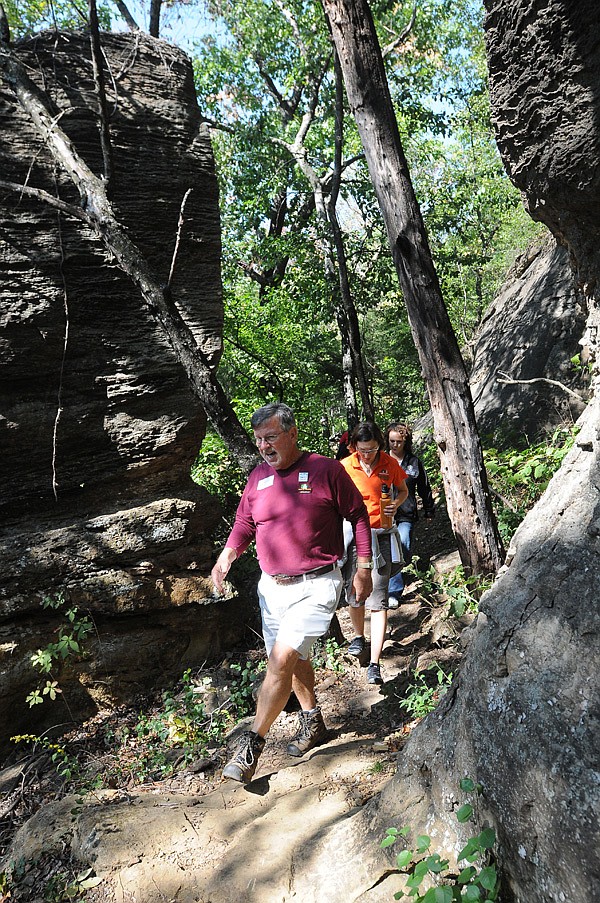 Mike Lemaster, president of the Ozark Highlands Trail Association, walks one of the Mount Kessler trails in Fayetteville Oct. 4. Conservation groups and individuals hope the University of Arkansas will purchase a 630-acre tract that includes flat land for sports fields and hilly terrain with trails for hiking, mountain biking and outdoor studies.