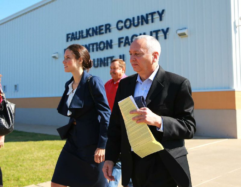 Jack Gillean, former University of Central Arkansas chief of staff, leaves the Faulkner County jail Wednesday morning in Conway with his attorney, Nicki Nicolo, after surrendering on felony charges and posting bond. 
