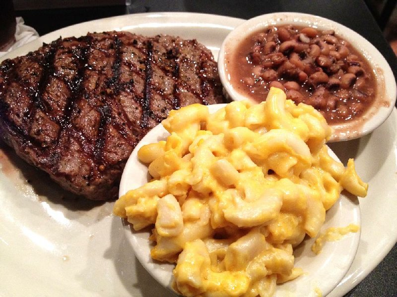 Rib-eye with macaroni and cheese and purple hull peas at Homer’s West. 