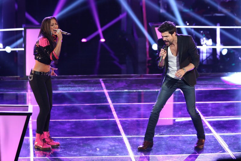 Beebe native Cody Belew, right, battles Domo during a recent episode of NBC’s The Voice. The duo sang Lady Gaga’s “Telephone” in the battle round, and Belew was selected as the winner.