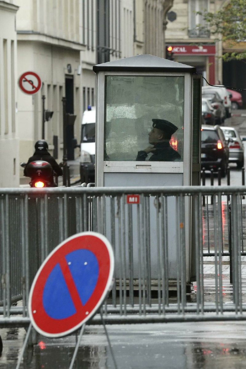 A French police officer keeps watch over a Paris synagogue Monday. A nation shamed by its collusion with the Nazis that sent thousands of Jews to their deaths during World War II is trying to crack down on anti-Semitism. 