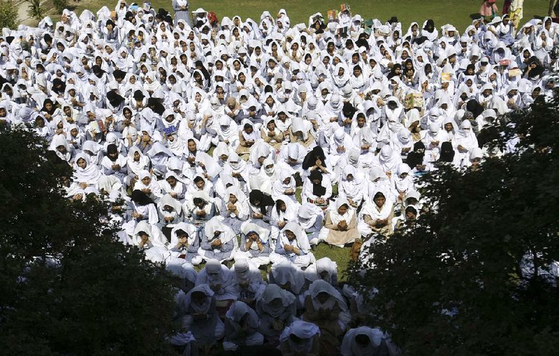 Students pray Friday in Peshawar, Pakistan, for the recovery of 14-year-old schoolgirl who was shot by the Taliban on Tuesday for speaking out in support of education for women. 