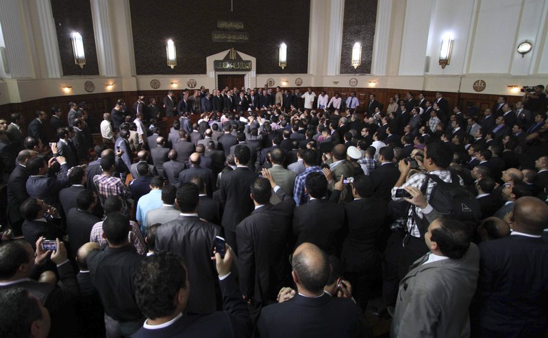 Egyptian Prosecutor General Abdel-Meguid Mahmoud speaks to hundreds of supporters, judges, lawyers and media in a downtown courthouse defying a presidential decision to remove him from his post, saying this infringes on the judiciary's independence, in Cairo, Egypt, Saturday, October 13, 2012. President Mohammed Morsi ordered Prosecutor General Abdel-Meguid Mahmoud to step down to appease public anger over the acquittals of ex-regime officials accused of orchestrating violence against protesters last year.