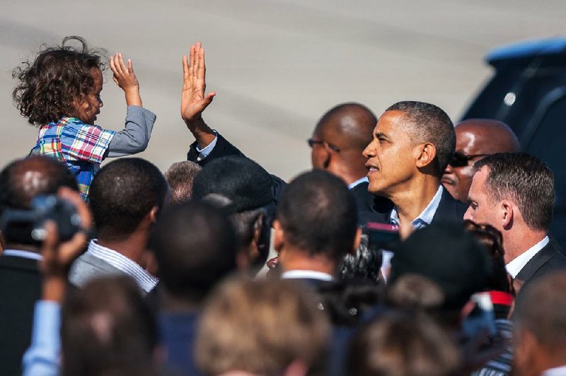 A young supporter greets President Barack Obama as he arrives Saturday at the Newport News, Va., airport. 