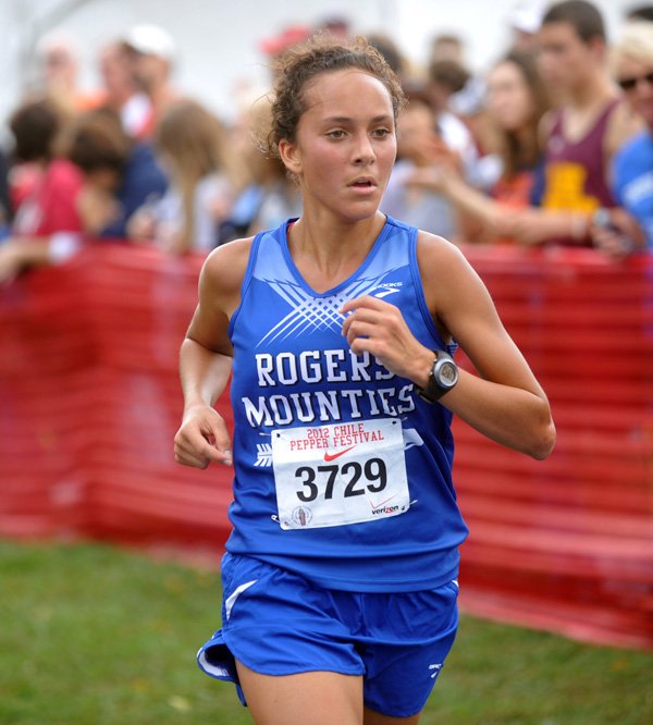 Maggie Montoya of Rogers High crosses the finish line to take sixth place in the high school girls 5,000-meter run of the Chile Pepper Cross Country Festival in Fayetteville. 