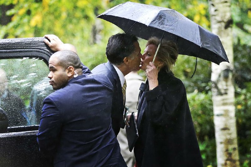 Republican presidential candidate Mitt Romney kisses his wife, Ann, as he leaves the Church of Jesus Christ of Latter-day Saints in Belmont, Mass., on Sunday. 