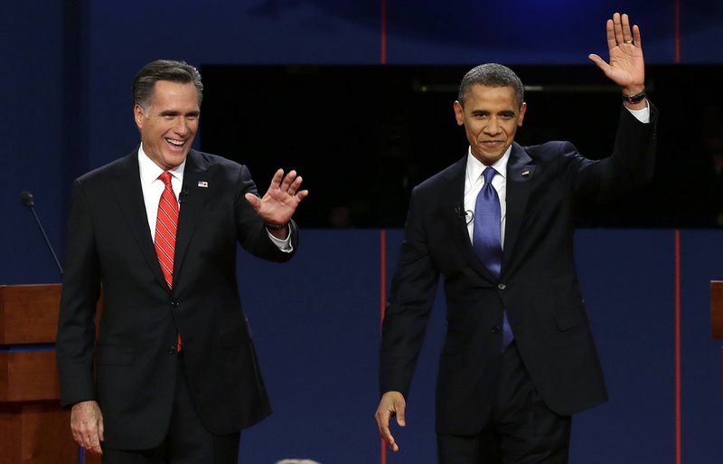 Republican presidential candidate Mitt Romney and President Barack Obama wave to the audience during the first presidential debate at the University of Denver in this Oct. 3, 2012, file photo.