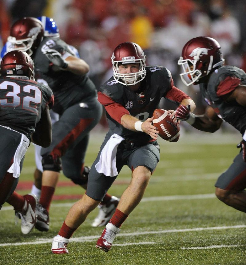 The Razorbacks will have to help their tackles to protect quarterback Tyler Wilson (shown) and the passing game against the LSU Tigers’ talented pass rushers.