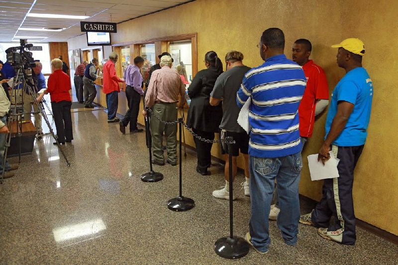 In this file photo tax payers wait in line at the Pulaski County treasurer's office.