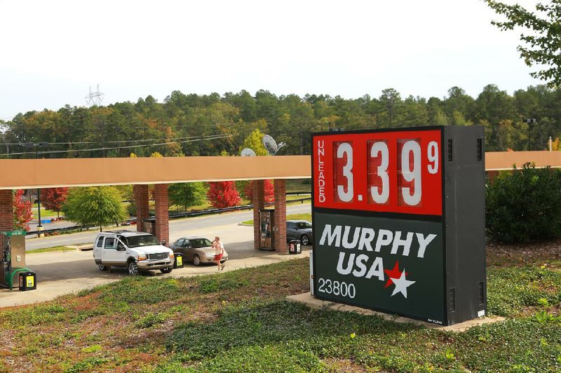 Motorists fill up Tuesday at the Murphy Oil USA station at 23800 Chenal Parkway in Little Rock. 