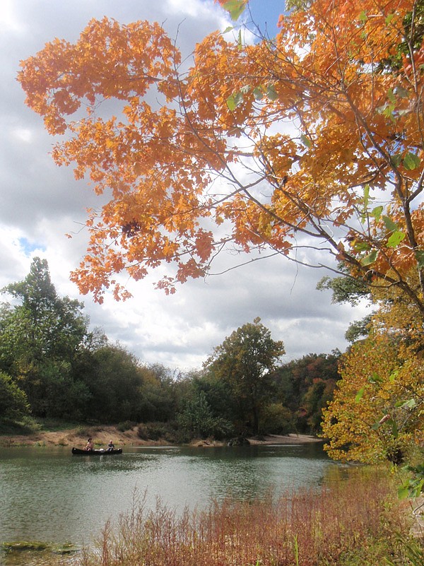 Trees cloaked in fall color greet a trio of paddlers on a two-day Kings River float trip. Matt Hughes, left, of Lone Jack, Mo., left, and his brother, Mark Hughes, alias “Hog Ears” Hughes, of Alaska, drifted down the Kings on Sunday and Monday to fish for smallmouth bass and enjoy a night of gravel-bar camping.