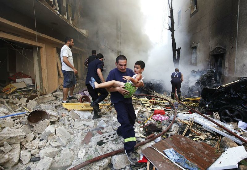 A rescuer in Beirut carries an injured child from the scene of a car bombing Friday in the Lebanese city’s Christian neighborhood. 