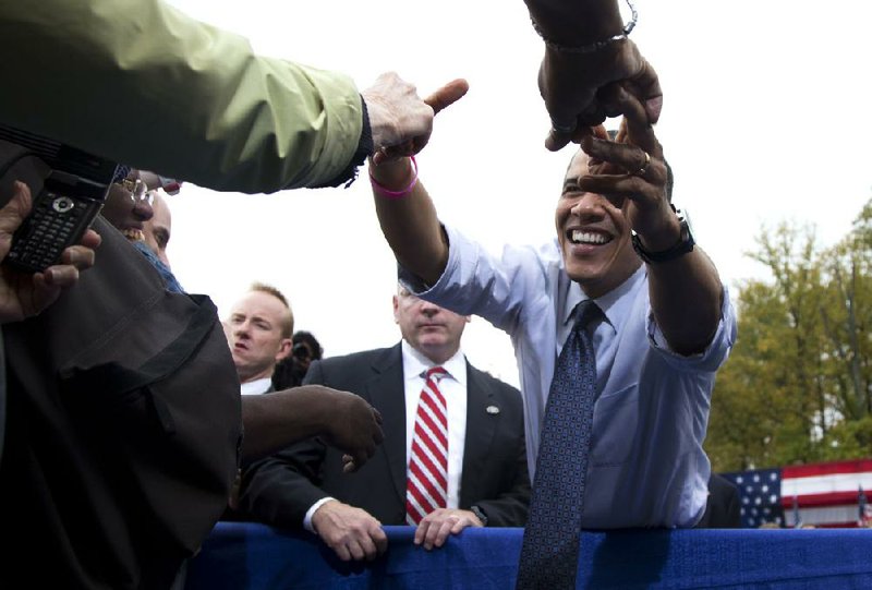 President Barack Obama greets supporters Friday after speaking at a campaign rally at George Mason University in Fairfax, Va.


