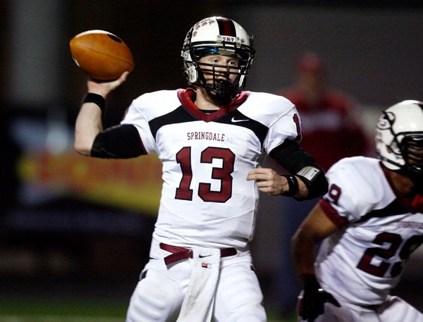 Will Whatley, Springdale quarterback, attempts a pass Friday against Rogers Heritage during the first half at Gates Stadium in Rogers.