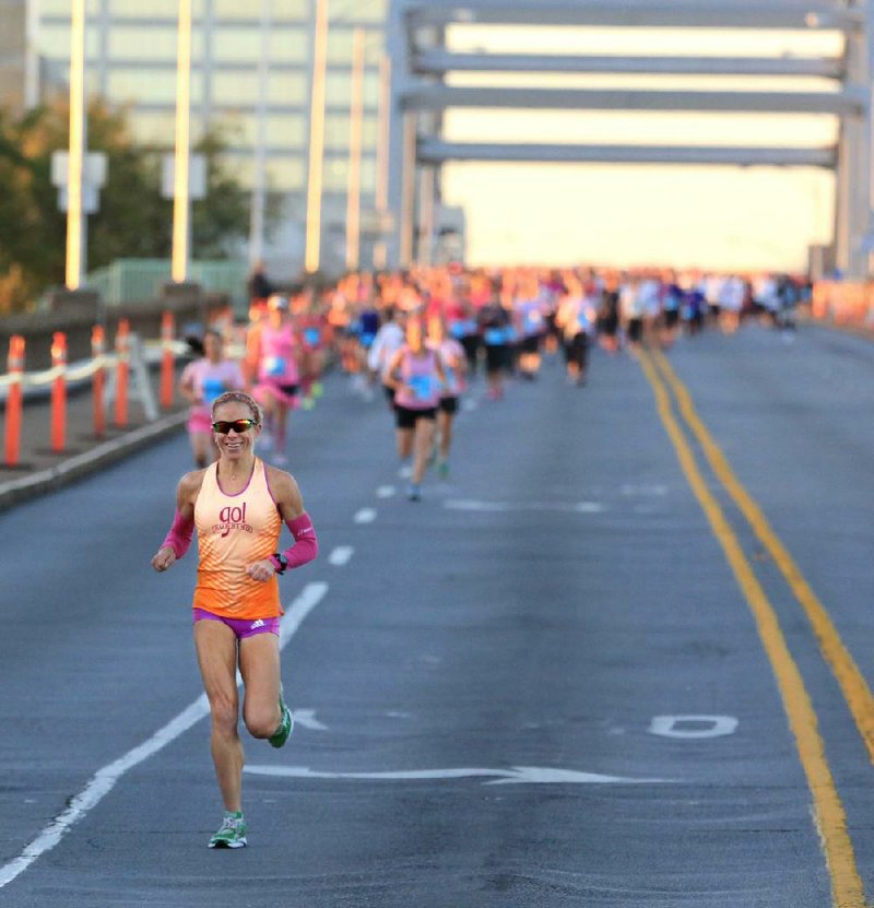 Leah Thorvilson of Little Rock leads the field of around 550 competitive runners across the Broadway Bridge in the Susan G. Komen Race for the Cure on Saturday in Little Rock and North Little Rock. Thorvilson, using the 5K race as a training run for next month’s New York City Marathon, won in 17 minutes, 55.79 seconds. 