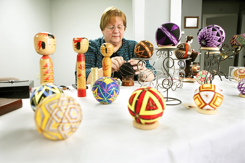Dolores Middleton works on a temari ball at the Arkadelphia Arts Center during the sixth annual Round About Artist Studio Tour. Temari is a traditional Japanese art form involving embroidered thread balls.