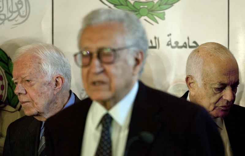 U.N.-Arab League envoy to Syria, Lakhdar Brahimi, center talks during a joint news conference with former U.S. President Jimmy Carter, left, and Arab League Secretary-General Nabil Elaraby after their meeting at the Arab League headquarters in Cairo on Wednesday, Oct. 24, 2012. 