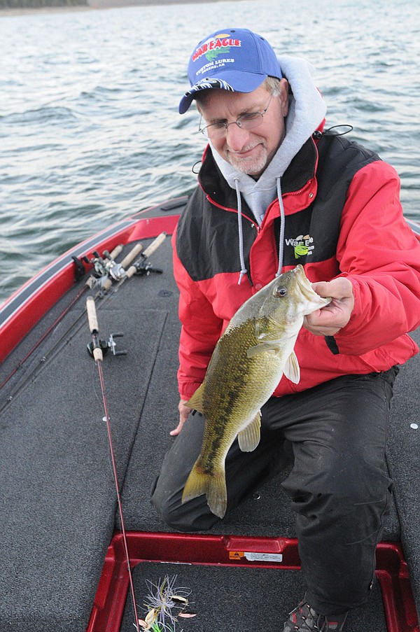 Keith Brashers shows a spotted bass that bit a spinner bait at Beaver Lake. Brashers owns War Eagle Custom Lures in Rogers and put his company’s spinner baits to the test on Friday.