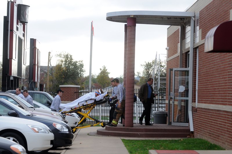 A patient is removed from the Springdale High School ninth-grade ALE building Friday morning.