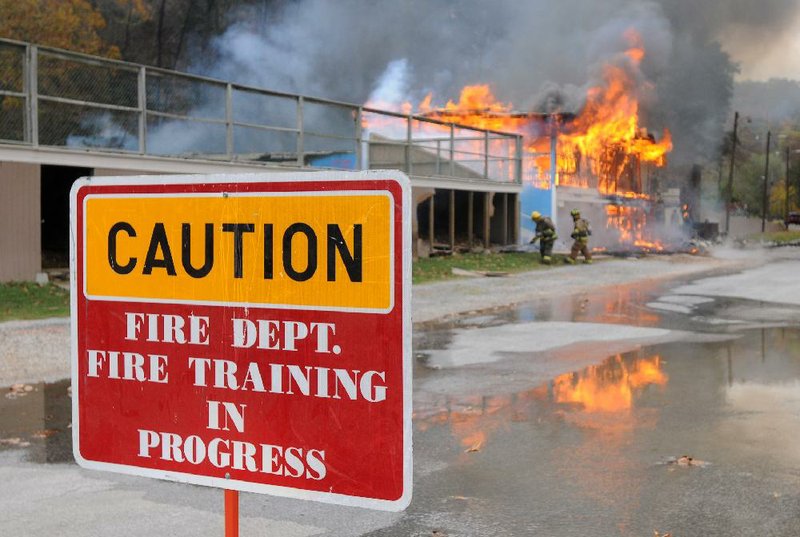 Firefighters burn Lakeside Restaurant Friday, Oct. 26, 2012, at Lake Atalanta in Rogers during a training exercise for the Rogers Fire Department and their Rookie Training Academy.