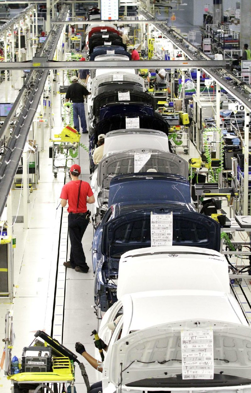 Employees at Toyota’s manufacturing plant in Blue Springs, Miss., assemble Corollas this week. Toyota’s lead over General Motors in global vehicle sales widened in the first nine months of 2012. 