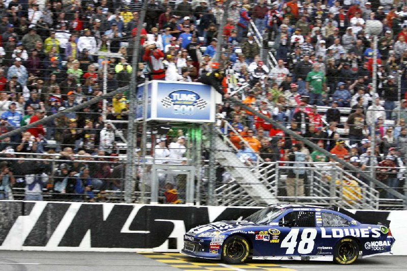 NASCAR Sprint Cup driver Jimmie Johnson crosses the finish line to win Sunday’s NASCAR Sprint Cup race at Martinsville Speedway in Martinsville, Va. With the victory, Johnson takes a two-point lead in the Chase for the Sprint Cup standings. 