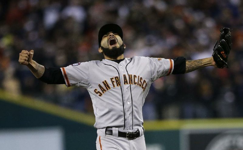 San Francisco Giants reliever Sergio Romo celebrates Sunday after striking out Detroit Tigers third baseman Miguel Cabrera in the 10th inning of their World Series game in Detroit. The Giants won 4-3 and clinched the championship 4-0. 