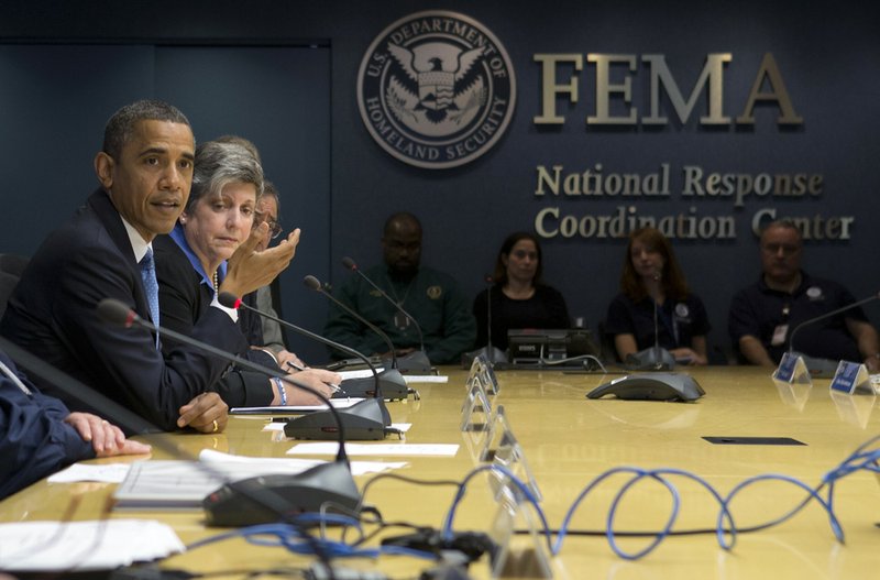 President Barack Obama, accompanied by Homeland Security Secretary Janet Napolitano, second from left, and others, speaks about superstorm Sandy during a visit to the Federal Emergency Management Agency headquarters in Washington on Wednesday, Oct. 31, 2012. 