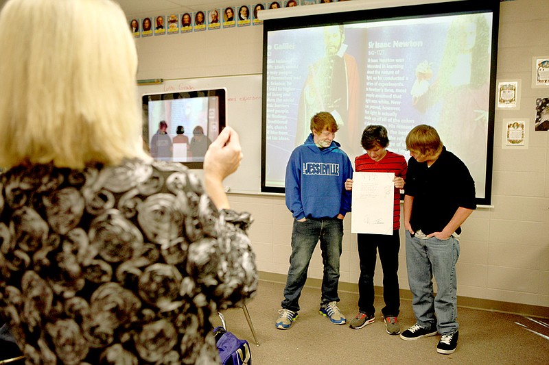 Gaye Johnson uses an iPad to record a presentation about famous scientists by Drew Galloway, from left, Dakota Fortenberry, and Bryan Long. The project is part of the Jessieville School System’s initiative to increase project-based learning.