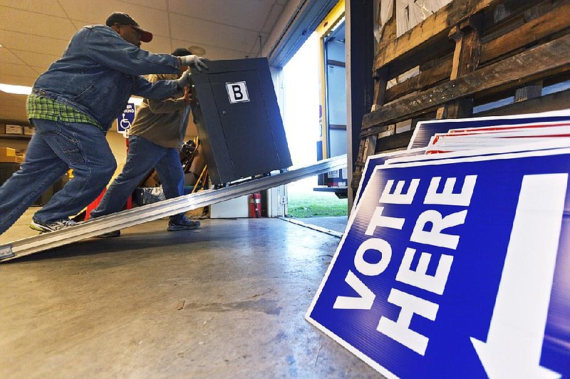 Delivery driver Ralph Nelson pushes a vote-counting scanner into a truck at the Pulaski County Election Commission warehouse in Little Rock in this Wednesday, Oct. 31, 2012, file photo. (AP Photo/Danny Johnston)