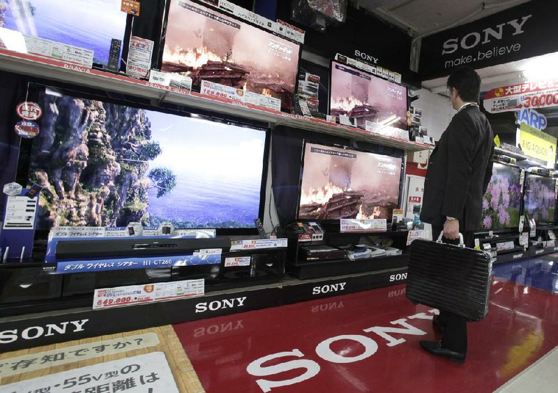 A man looks at Sony flat-screen televisions displayed Thursday at a Tokyo electronics store. 