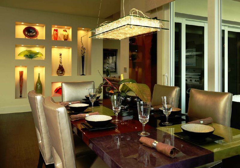 A glass, metal and exposed wire chandelier complements the rectangular shape of a custom dining room table. 