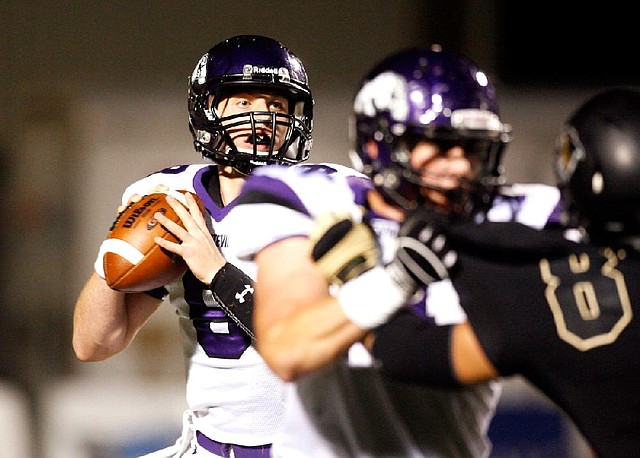 Fayetteville quarterback Austin Allen looks for a receiver in the first half of a 24-17 loss to top ranked Bentonville on Friday at Tiger Stadium in Bentonville. Allen threw for 194 yards. 