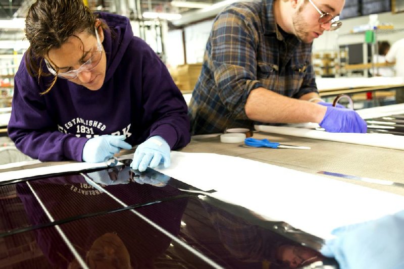 Employees at the Xunlight Corp. factory in Toledo, Ohio, work on a solar panel in September. Orders for manufactured goods rose 4.8 percent in September, the Commerce Department said Friday. 