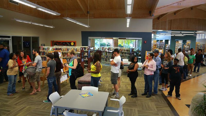 The line for early voting Saturday afternoon stretches through the Sue Cowan Williams Library on Chester Street in Little Rock. 