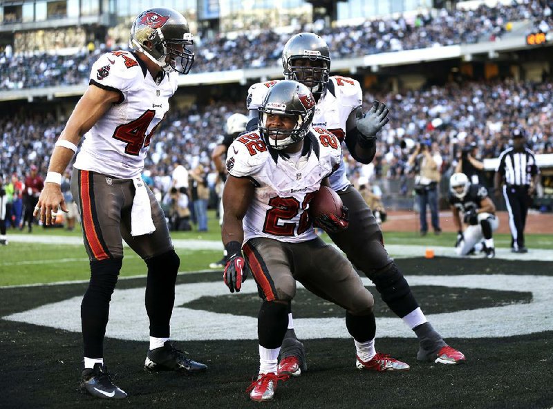Tampa Bay Buccaneers rookie running back Doug Martin (center) rushed for a franchise-record 251 yards and four touchdowns Sunday against the Oakland Raiders. Martin finished 45 yards shy of tying Adrian Peterson’s single-game record of 296 set in his rookie season in 2007. 