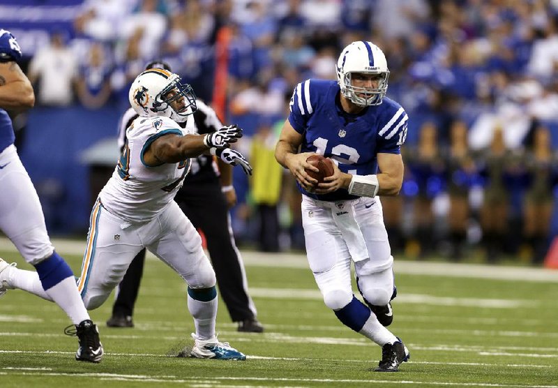 Indianapolis Colts quarterback Andrew Luck threw for 433 yards Sunday against the Miami Dolphins, breaking the NFL record for most passing yards in a single game by a rookie. 
