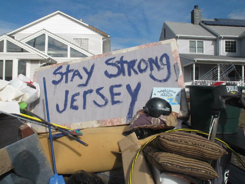 Residents of a flood-wrecked home in Point Pleasant Beach, N.J., offer encouragement to fellow victims of superstorm Sandy in this message on the bottom of a mattress Monday. 