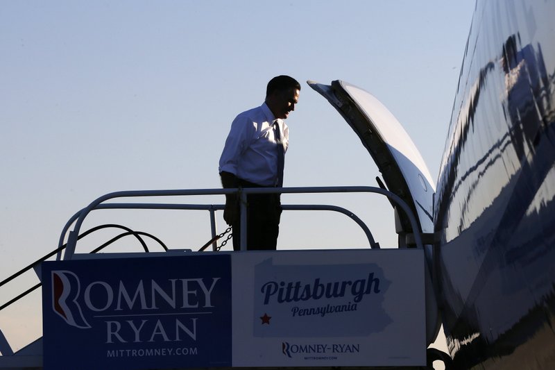 Republican presidential candidate, former Massachusetts Gov. Mitt Romney returns to his campaign plane at Moon Township Pittsburgh International Airport in Coraopolis, Pa., after he visited a call center in the Pittsburgh area, Tuesday, Nov. 6, 2012.