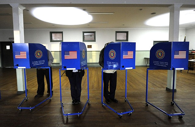 Voters cast their ballots at Bishop Molloy Recreational Center on Tuesday, Nov. 6, 2012, in Point Lookout , N.Y., one of several voting locations that were created as a result of Superstorm Sandy.