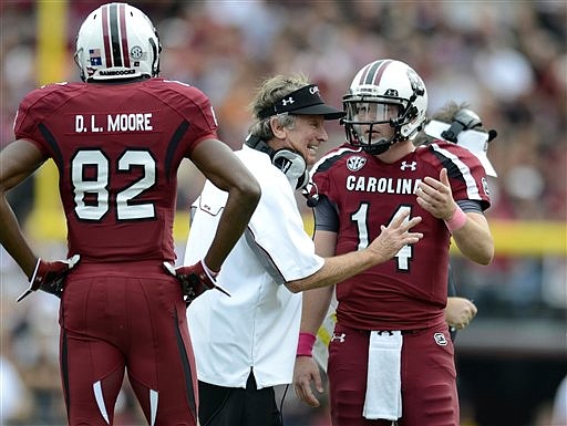 South Carolina coach Steve Spurrier talks to quarterback Connor Shaw asD. L. Moore looks on during the first half of an NCAA college football game against Tennessee, Saturday, Oct. 27, 2012, at Williams-Brice Stadium in Columbia, S.C.(AP Photo/Richard Shiro)