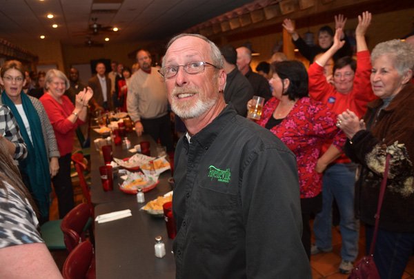 Fayetteville Mayor Lioneld Jordan looks up at the TV to see the latest results Tuesday evening as supporters show their excitement with the results during the post-election watch party for the city’s mayor race at Mexico Viejo in Fayetteville. 