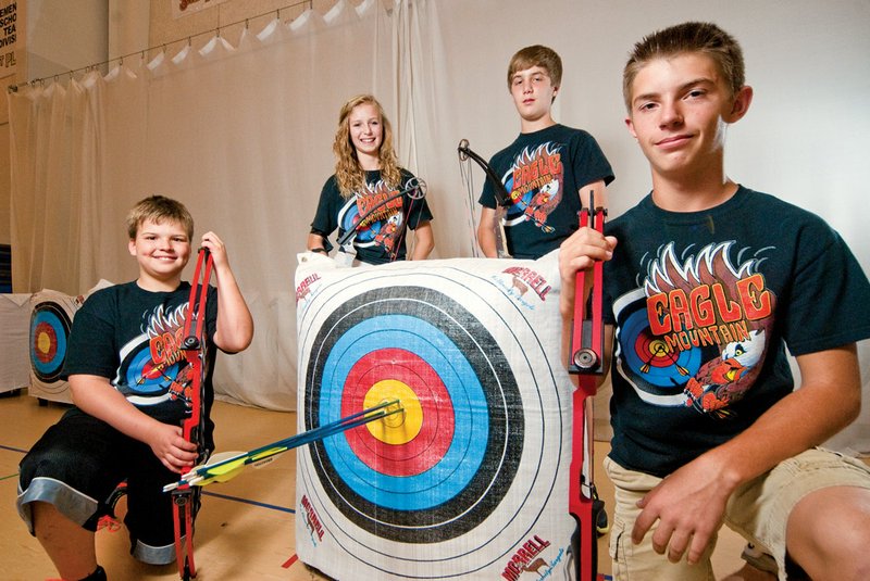 From the left, Jack Allen, Gina Mishark, Jack Looney and Ronnie Jeffery are members of the Eagle Mountain Magnet School archery team.