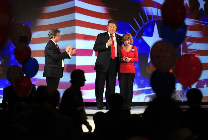 State Rep. Allen Kerr (center) and his wife address a crowd of Republican supporters at an election watch party Tuesday at Embassy Suites in Little Rock.