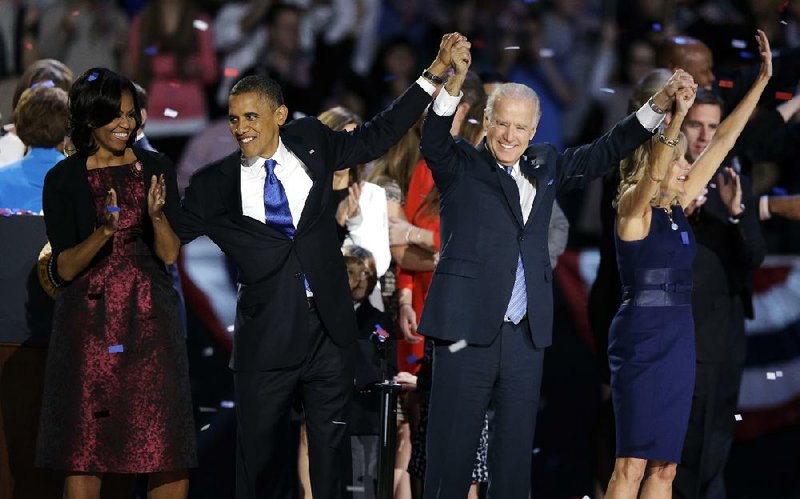 President Barack Obama, first lady Michelle Obama, Vice President Joe Biden and Jill Biden acknowledge the crowd at his election night party Wednesday, Nov. 7, 2012, in Chicago. President Obama defeated Republican challenger former Massachusetts Gov. Mitt Romney. (AP Photo/Chris Carlson)